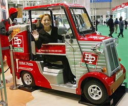Mitsuoka Motor Co saleswoman Aki Yoshida waves from the Micro Car