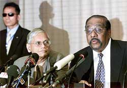 LTTEs chief negotiator Anton Balasingham speaks alongside Sri Lankan Governments chief negotiator G.L. Peiris during a news conference