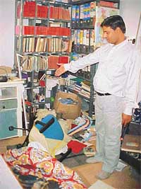 A sewadar showing a ransacked room at the Bapu Asa Ram ashram