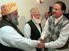 Makhdoom Amin Fahim (right), leader of Benazir Bhutto's Pakistan People's Party, shakes hands with Mulana Fazlur Rehman