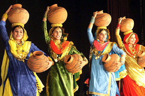 Girls carry earthen pitchers during a cultural function in Amritsar on Thursday.