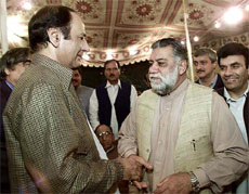 Chaudhry Shujat (left), leader of the pro-Pervez Musharraf party, greets Zafarullah Jamali