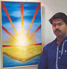 Artist Parveen Kumar poses with his painting "Idam Shariram" at IndusInd Art Gallery, Sector 8, Chandigarh, on Monday.