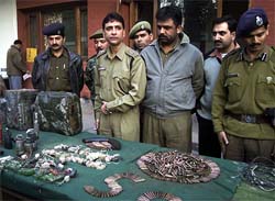 Jammu and Kashmir police officials display large quantity of arms and ammunition