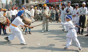 Sikh youths perform "gatka" during a nagar kirtan