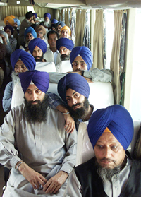 Sikh pilgrims leave Lahore city for Nankana Sahib by bus on Sunday. 