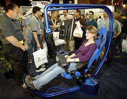 A consumer tests out a new ergonomic computer chair during the opening day of Comdex 2002, in Las Vegas on Monday. 