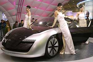 Models pose next to Hyundai Motor Co's new concept "HIC" car at the Seoul Motor show on Wednesday