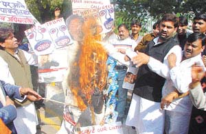 National Human Rights Council activists burn an effigy of Union Minister Pramod Mahajan during a demonstration at Jantar Mantar in the Capital on Wednesday