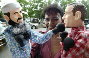 An enterprising Filipino vendor sells puppets that look like US President George W. Bush and al-Qaida leader Osama bin Laden in Manila 