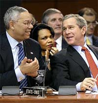 US President George W. Bush and Secretary of State Colin Powell talk as National Security Adviser Condoleezza Rice listens at the North Atlantic Council Summit in Prague