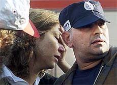 An Israeli woman is comforted at the scene of a Palestinian suicide bomb attack