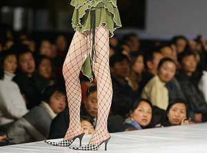 A Chinese model displays an outfit during the New Designers fashion show on Friday in Beijing.