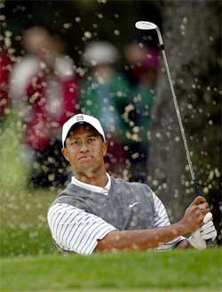 Tiger Woods of the USA watches his shot