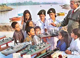 Children watch models of ships on display as part of the NCC Day celebrations at the Lake Club 