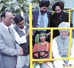 Leader of Opposition in the Rajya Sabha Manmohan Singh with a student of Mata Jai Kaur Public School after the inauguration of a play, Unleashed