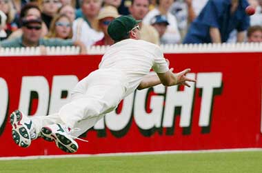 Australias Glenn McGrath is airborne as he dives to take a catch to dismiss Englands Michael Vaughan