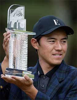 Kaname Yokoo of Japan shows off the winners trophy