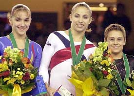New world champion Courtney Kupets from the USA is flanked by 2nd placed Ioana Petrovschi from Romania and 3rd placed Lioudmila Eyova from Russia