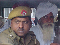 Bharatiya Kisan Union president Ghasi Ram Nain being taken to the central jail