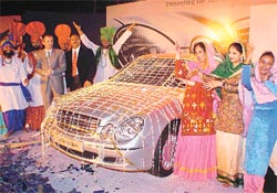 A proud Mr Hans-Michael Huber, CEO and MD of Diamler Chrysler India Pvt Ltd, and Mr Manjit Singh Bala, MD of Tai-Pan Traders, look on as the Mercedes-Benz new E-class car