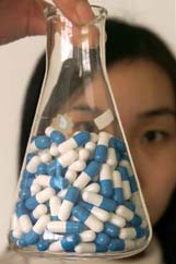 A Chinese laboratory worker shows samples of AIDS cocktail