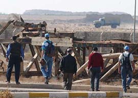 U.N. weapons inspectors view a metal structure