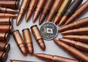 A badge of the Pakistan-based Jaish-e-Muhammad outfit calling for God's help and jehad lie among the loose ammunition