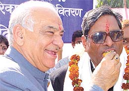 Delhi BJP president Madan Lal Khurana offering sweets to East Delhi MP Lal Bihari Tiwari on the latters 61st birthday at his residence in the Capital on Saturday