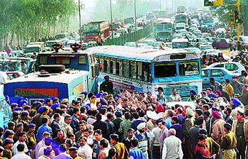 Thousands of commuters get caught in a long traffic jam, as traders block the Chandigarh-Panchkula road on Wednesday.