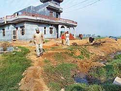 The house outside the village phirni that has been blocking the main drain of the village.