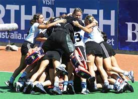 Argentina's hockey players pile on top of each other
