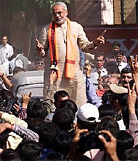 Caretaker Chief Minister Narendra Modi pacifies a group of voters