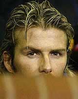 Manchester Uniteds David Beckham sits on the bench against Deportivo La Coruna during the Champions League 