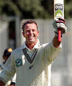 New Zealands Mark Richardson salutes the crowd after the ten-wicket defeat of India on the third day of the first cricket Test