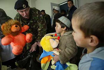Warrant Officer Class 2 Dave McGill of the British forces serving with the International Security Assistance Force gives toys to Afghan children at Indira Gandhi Hospital in Kabul