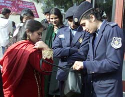 Policewomen check a womans purse outside a church on the occasion of Christmas in Islamabad on Wednesday.