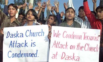 Pakistani children hold placards during a demonstration against an attack on a church