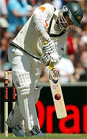 Australia's Justin Langer hits a four