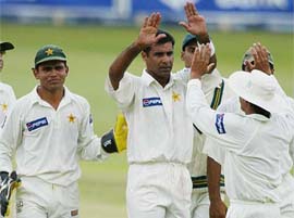 Pakistan captain Waqar Younis celebrates taking the wicket of South African batsman Neil McKenzie