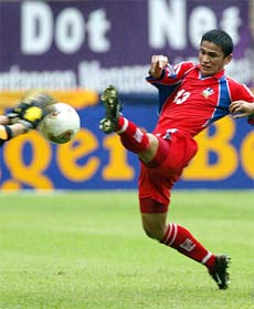 Vietnam's goalkeeper stops a shot from Thailand's Kiatisuk Senamuang