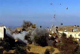 The house of a Palestinian belonging to the Al Aqsa Brigades, a militant group affiliated with Palestinian President Yasser Arafats Fatah faction, is blown up by Israeli troops