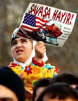 A girl appears over a crowd holding a banner
