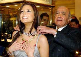 Harrods owner Mohammed al-Fayed places a necklace on Australian singer Holly Valance