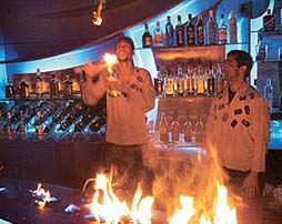 HIGH SPIRITS! A bartender in a Chandigarh restaurant juggles liquor bottles after setting the counter on fire in a spectacular show on New Year Eve