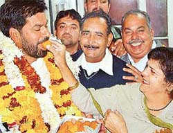 Mr Subhash Chawla's wife offers him a ladoo after he was elected the Mayor