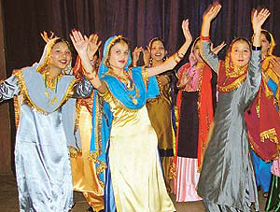 Students perform giddha during a folk dance competition 
