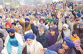 Farmers raise slogans following the governments announcement to release part payment of sugarcane dues 