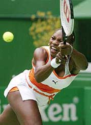 Serena Williams of the USA stretches for a shot from Emilie Loit of France