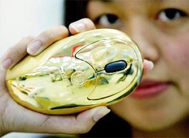 DATA IT employee displays a gold-plated computer mouse